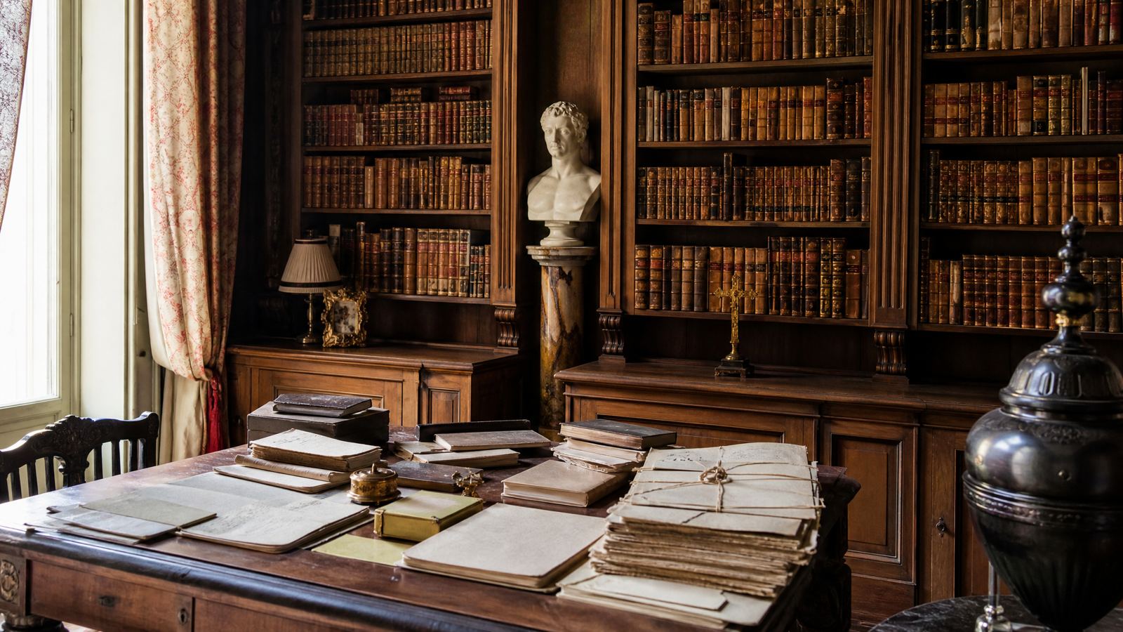 Library with old books and a Roman bust, Lebrija Palace, Seville